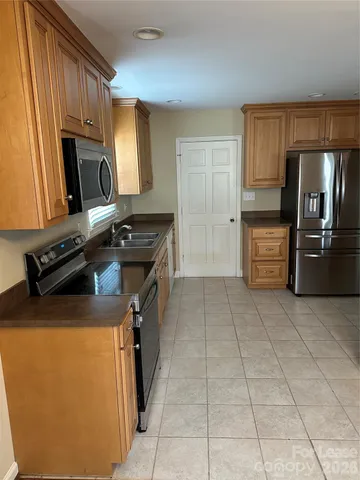 a kitchen with a refrigerator stove and sink