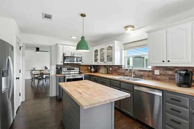 a kitchen with a sink a counter top space and appliances