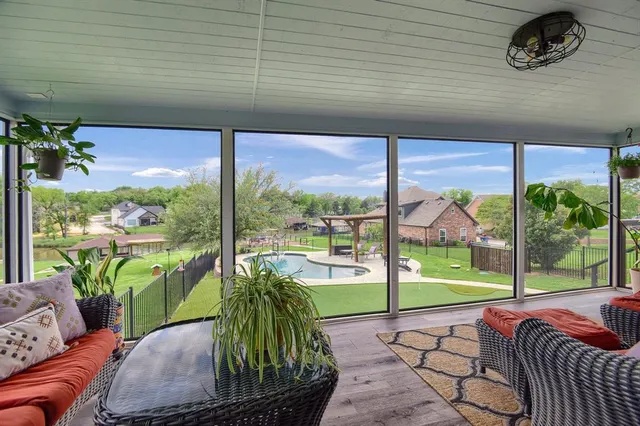 a view of a porch with furniture and garden