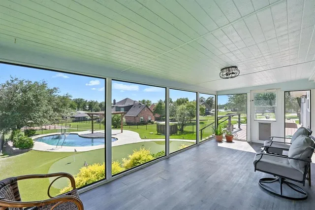 a view of a patio with a table chairs and a backyard