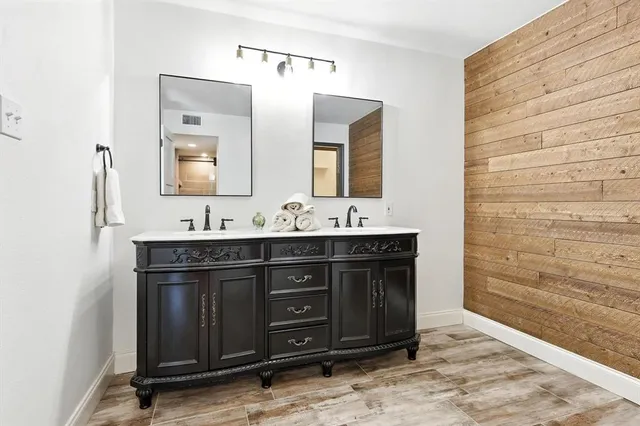 a bathroom with a sink vanity and mirror