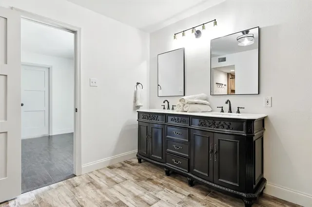 a bathroom with a sink vanity and mirror