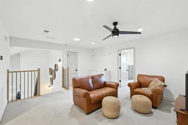 a living room with furniture ceiling fan and a rug