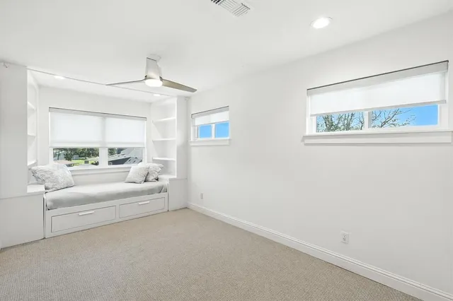 a view of a white house with furniture and a rug