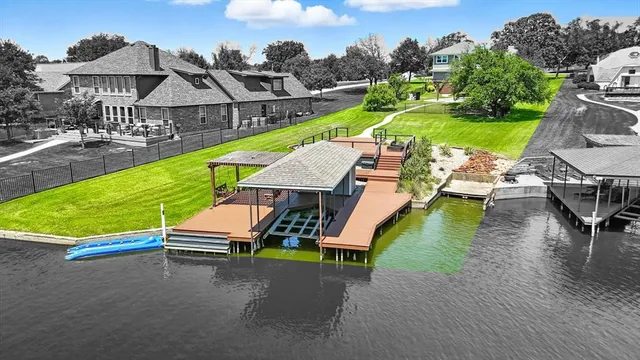 an aerial view of a house with a garden and houses