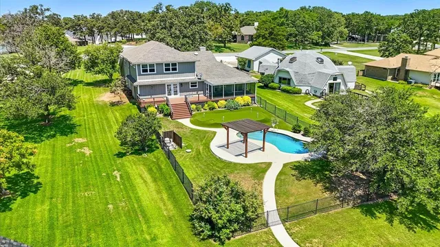 an aerial view of a house with swimming pool garden and patio