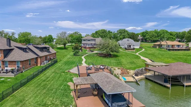 an aerial view of a house with swimming pool garden and patio