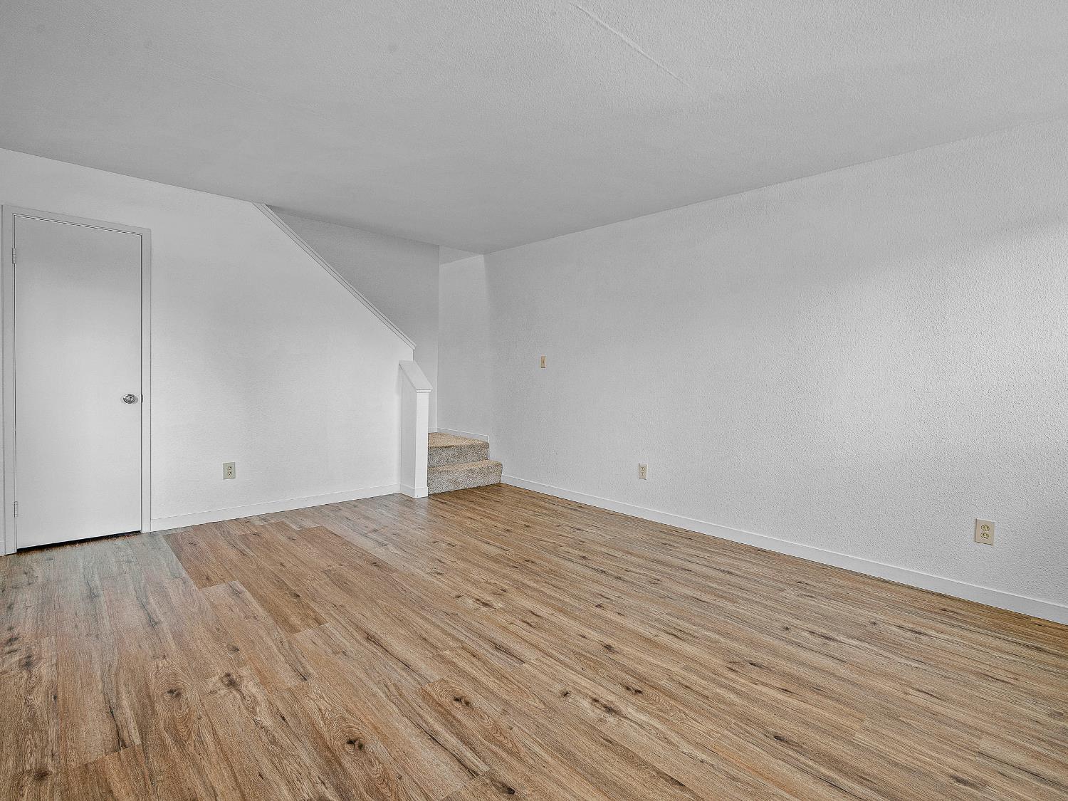 1519 Hood Road, Unit F Sacramento, CA 95825 - Photo 13 of 28 a view of an empty room with wooden floor