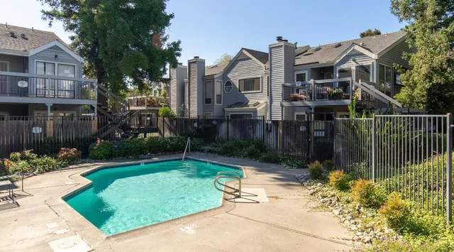 a view of a house with a small yard and plants
