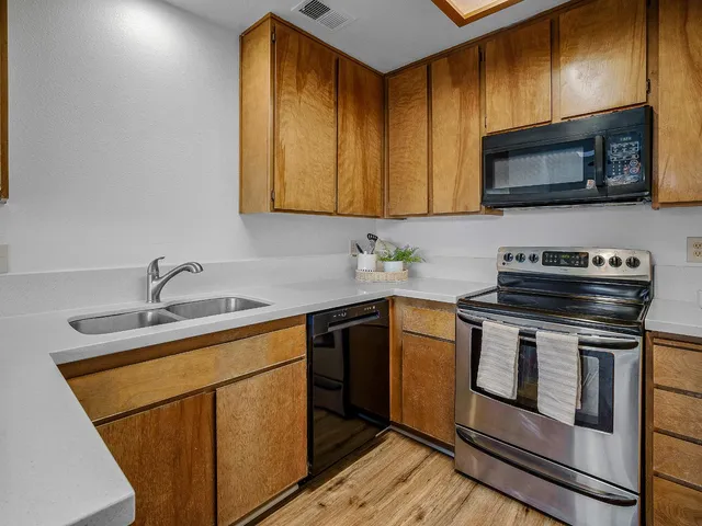 a kitchen with a sink stove and microwave