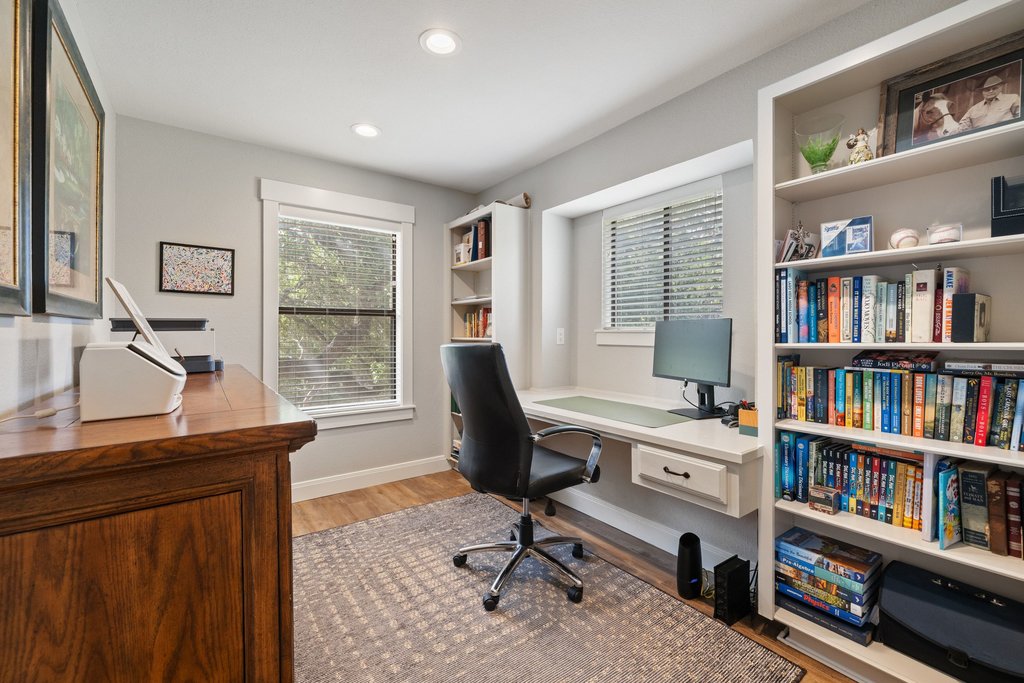 23644 Nameless Road Leander, TX 78641 - Photo 16 of 40 Built-in shelving and a dedicated desk nook create an efficient and organized home office space.
