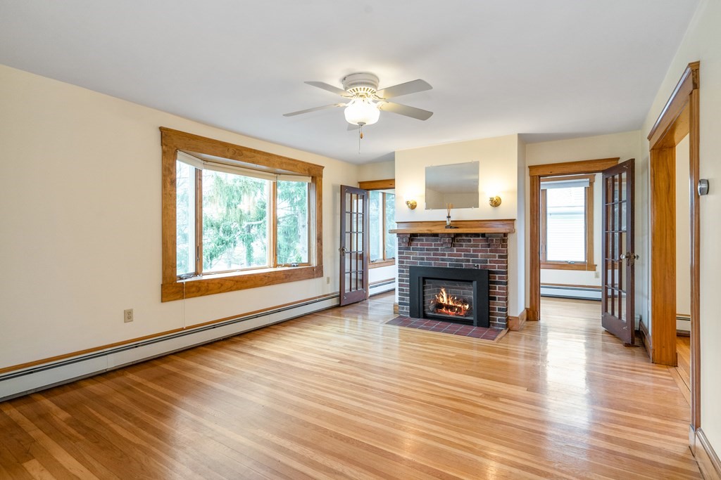 13-15 Fordham Road Newton, MA 02465 - Photo 12 of 30 a view of a livingroom with a fireplace wooden floor and windows
