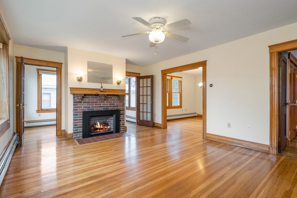 13-15 Fordham Road Newton, MA 02465 - Photo 13 of 30 a view of an empty room with wooden floor fireplace and a window