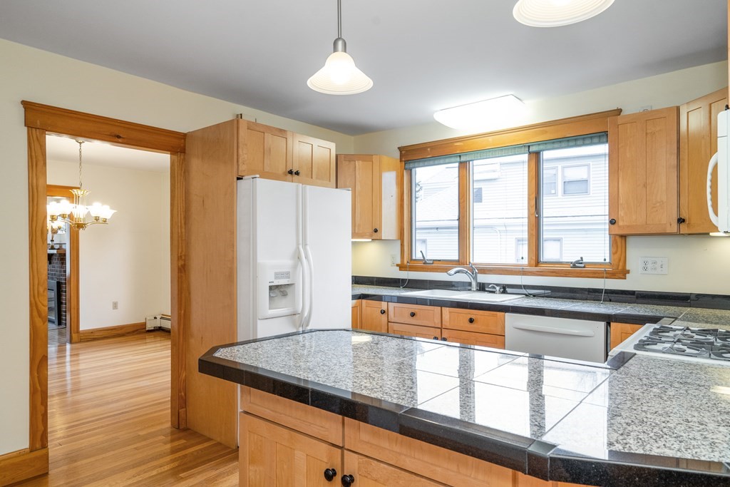 13-15 Fordham Road Newton, MA 02465 - Photo 16 of 30 a kitchen with stainless steel appliances granite countertop a stove a sink and a refrigerator
