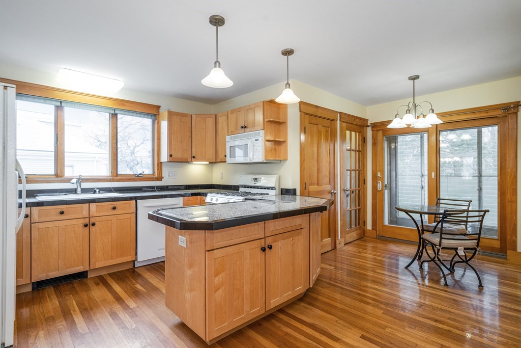 13-15 Fordham Road Newton, MA 02465 - Photo 17 of 30 a kitchen with stainless steel appliances granite countertop wooden floors stove and sink