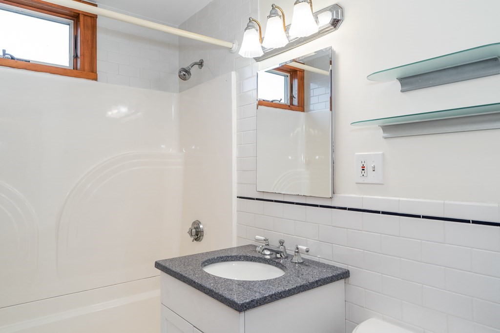 13-15 Fordham Road Newton, MA 02465 - Photo 20 of 30 a bathroom with a sink and a mirror