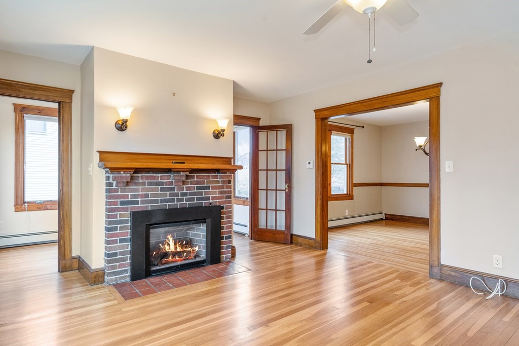 13-15 Fordham Road Newton, MA 02465 - Photo 3 of 30 a view of a livingroom with wooden floor and a fireplace