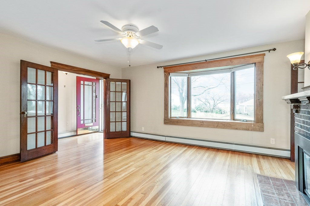 13-15 Fordham Road Newton, MA 02465 - Photo 4 of 30 a view of an empty room with a window and wooden floor