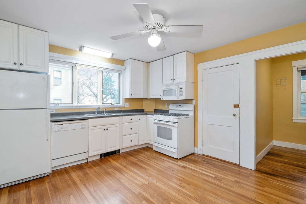 13-15 Fordham Road Newton, MA 02465 - Photo 7 of 30 a kitchen with granite countertop white cabinets and white appliances