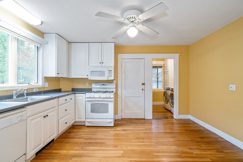 13-15 Fordham Road Newton, MA 02465 - Photo 8 of 30 a large kitchen with a large window a sink stainless steel appliances and cabinets