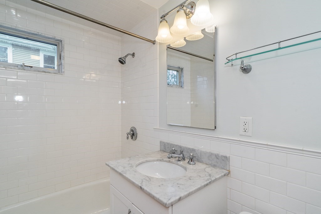 13-15 Fordham Road Newton, MA 02465 - Photo 10 of 30 a bathroom with a sink vanity granite tub shower and a mirror