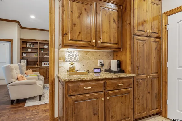 a kitchen with stainless steel appliances granite countertop a sink and cabinets