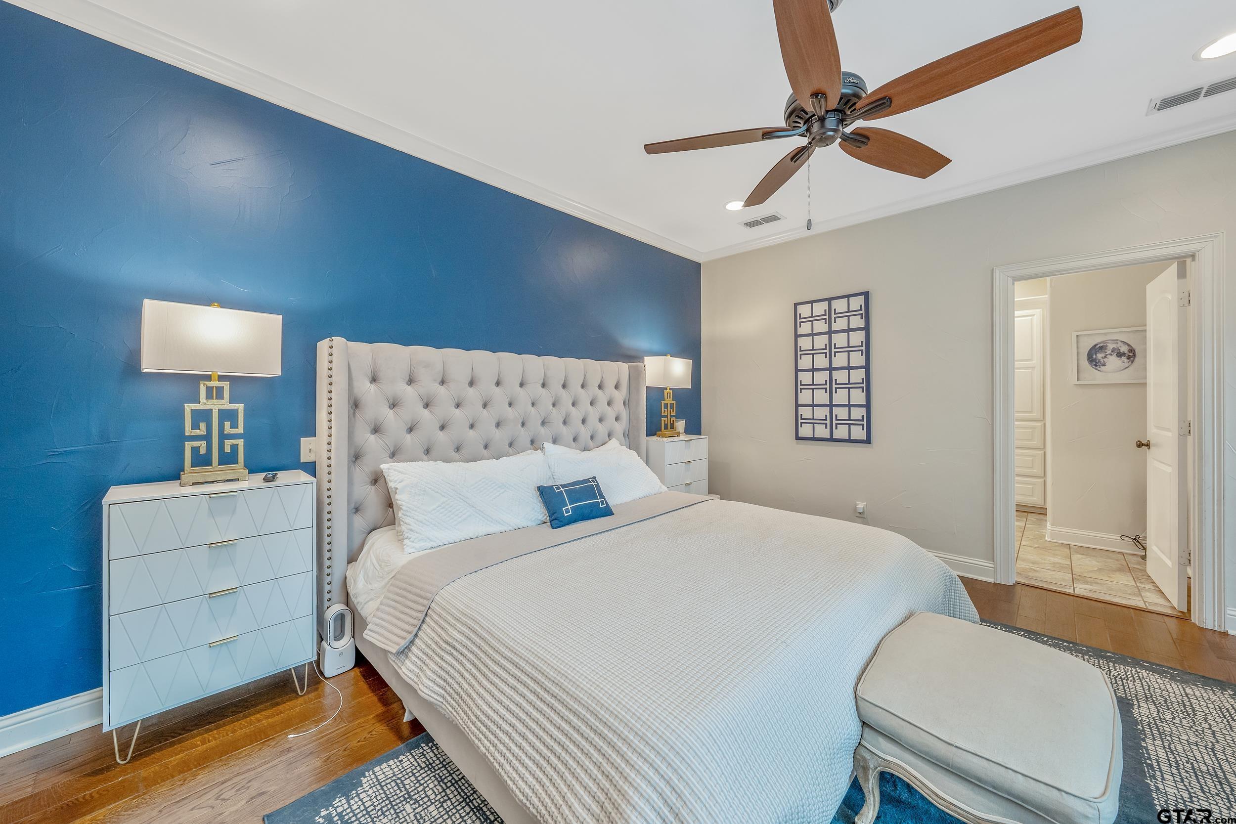 7216 Princedale Tyler, TX 75703 - Photo 14 of 27 a bedroom with a bed and a chandelier