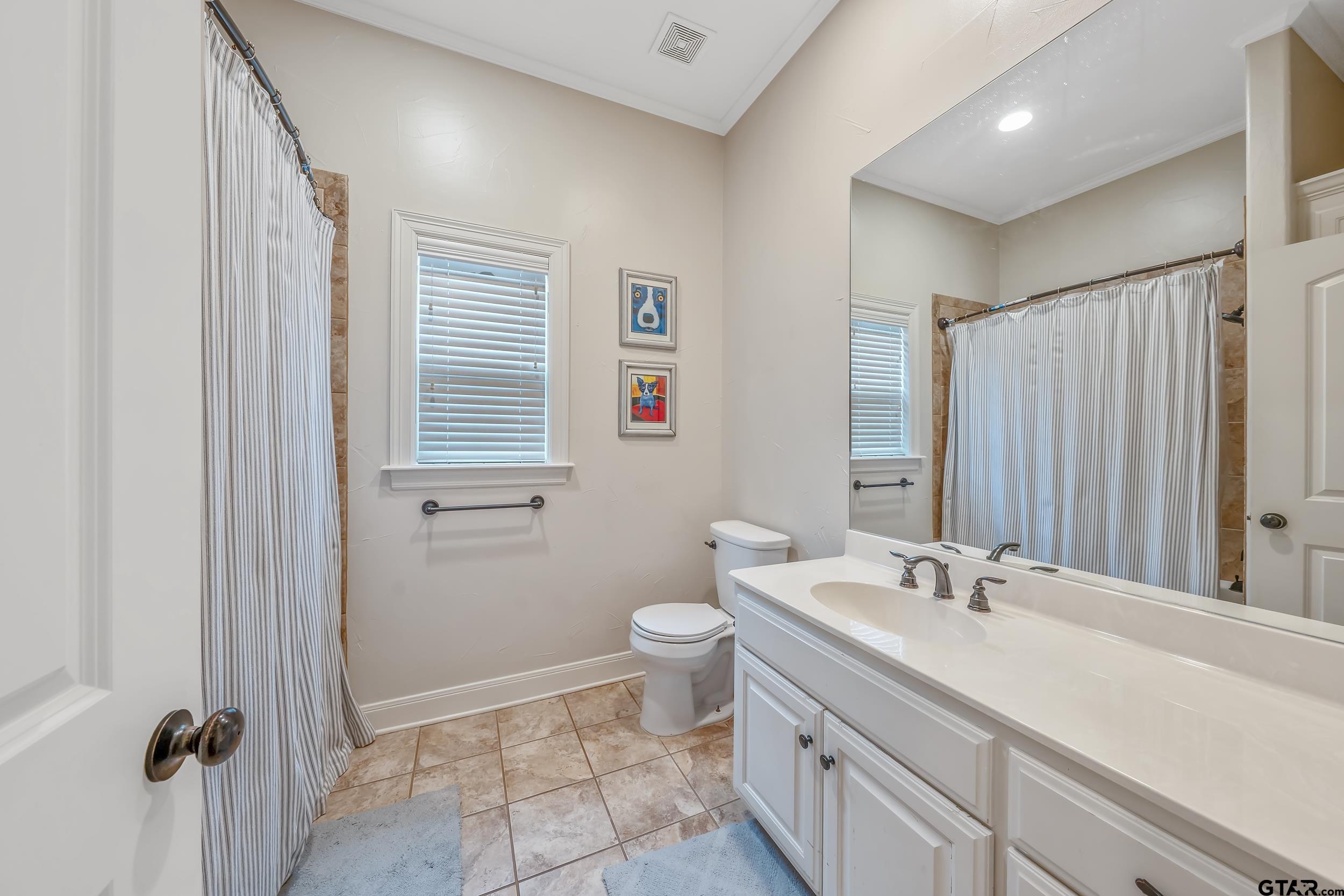 7216 Princedale Tyler, TX 75703 - Photo 18 of 27 a bathroom with a double vanity sink toilet and shower