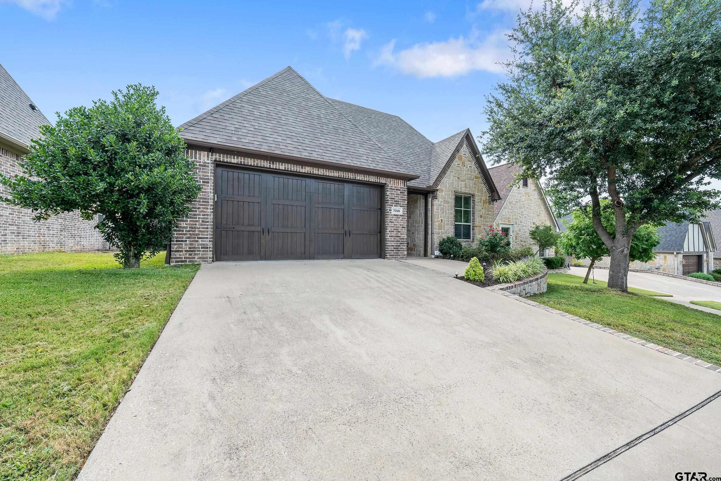 7216 Princedale Tyler, TX 75703 - Photo 2 of 27 a front view of a house with a yard and garage