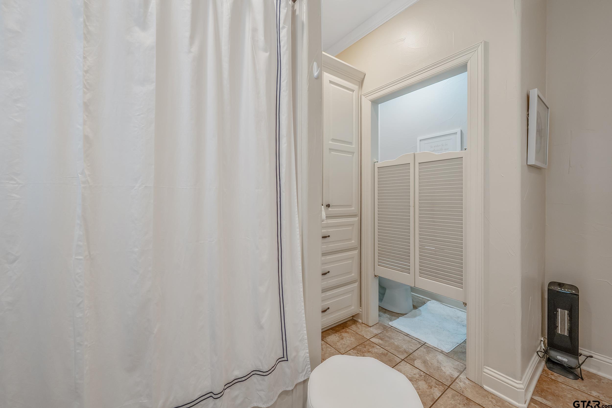 7216 Princedale Tyler, TX 75703 - Photo 21 of 27 a bathroom with a shower curtain