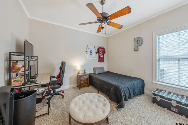 a bedroom with bed and a large window