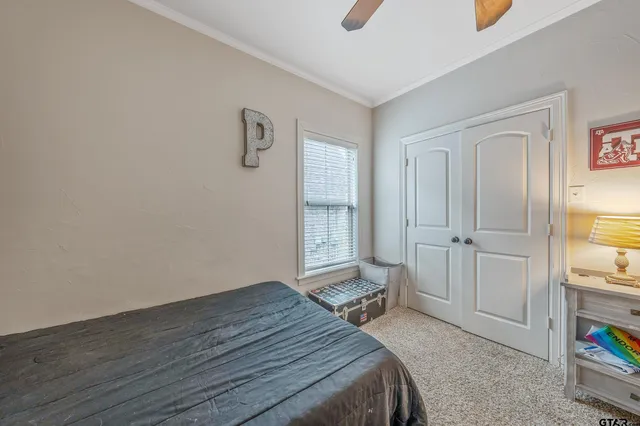 a bedroom with a bed and a window