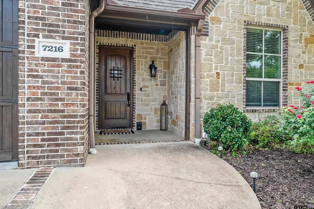 a front view of a building with potted plants