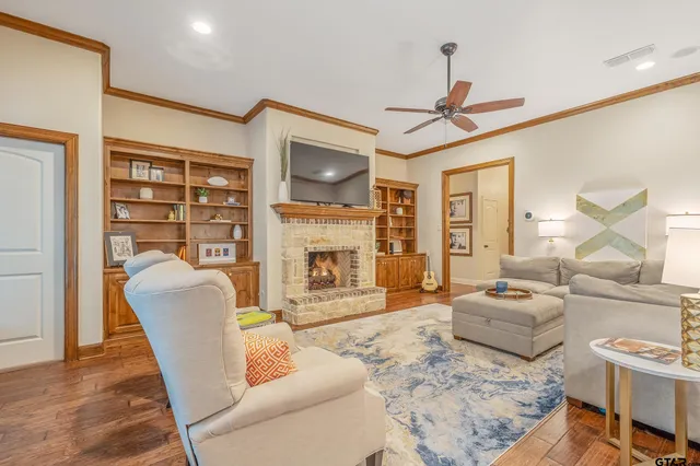 a living room with furniture a fireplace and a flat screen tv