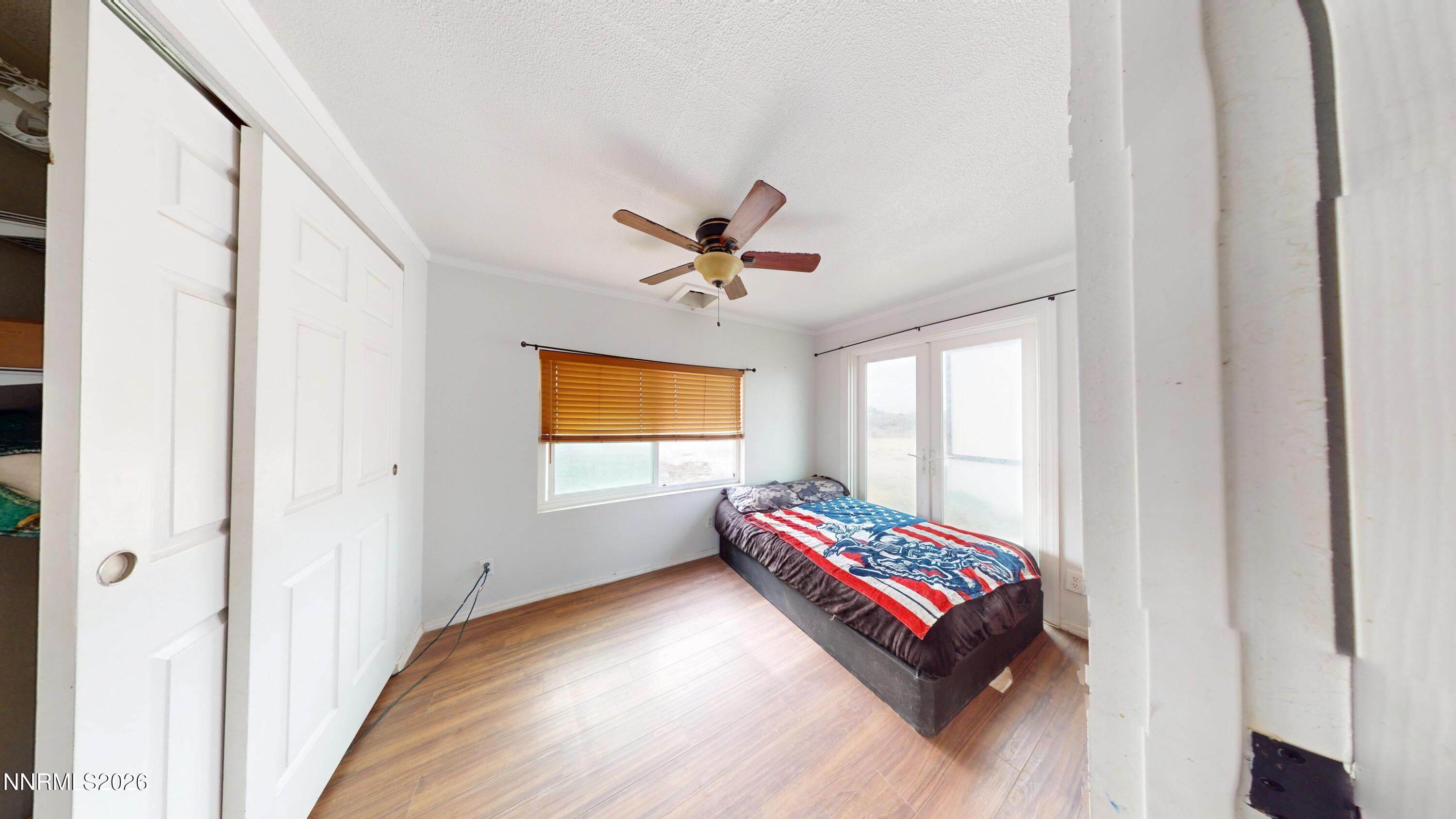 5355 Godchaux Road Winnemucca, NV 89445 - Photo 15 of 37 a living room with a bed and a ceiling fan