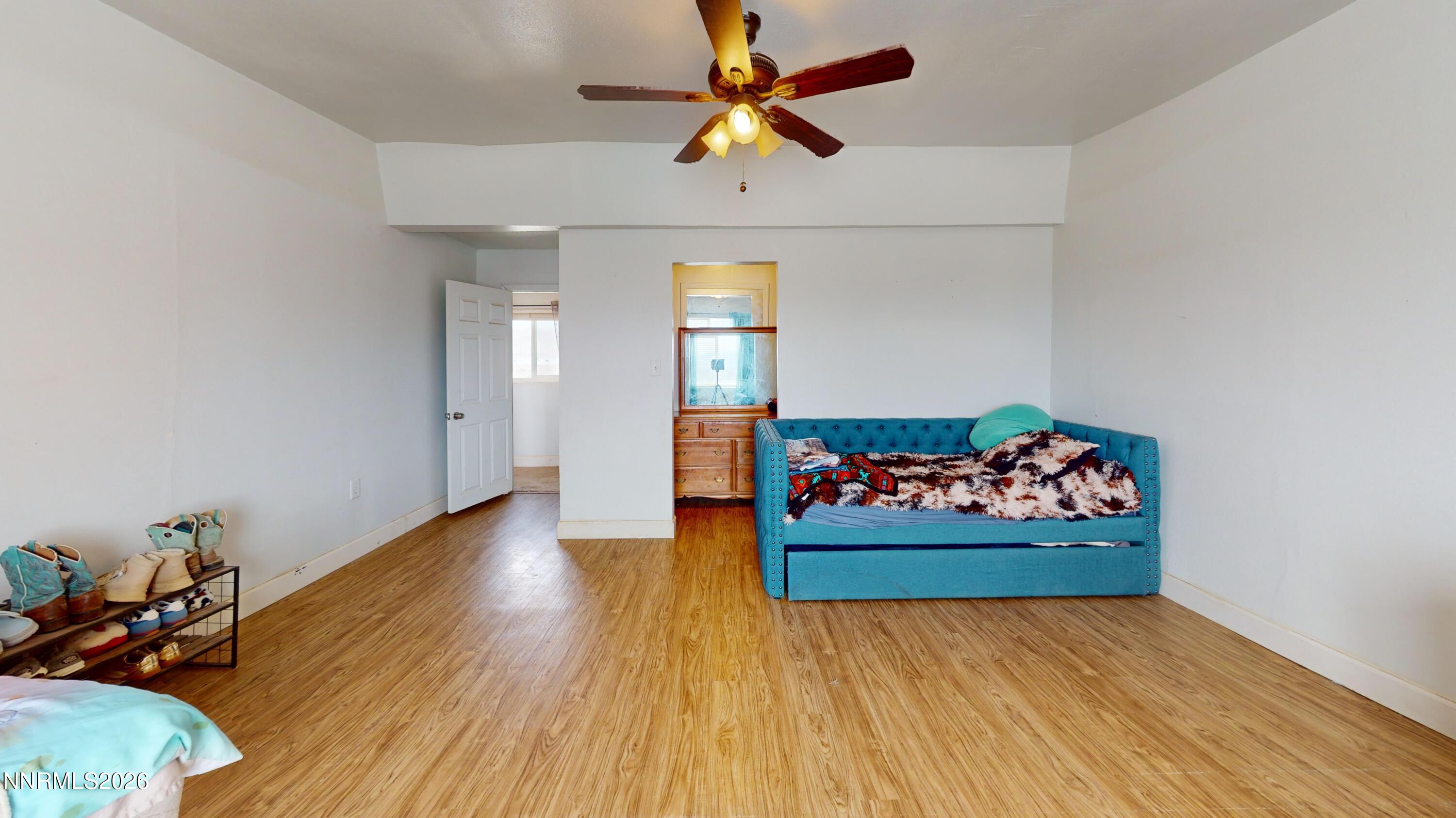 5355 Godchaux Road Winnemucca, NV 89445 - Photo 22 of 37 wooden floor in a room with a chandelier fan and wooden floor