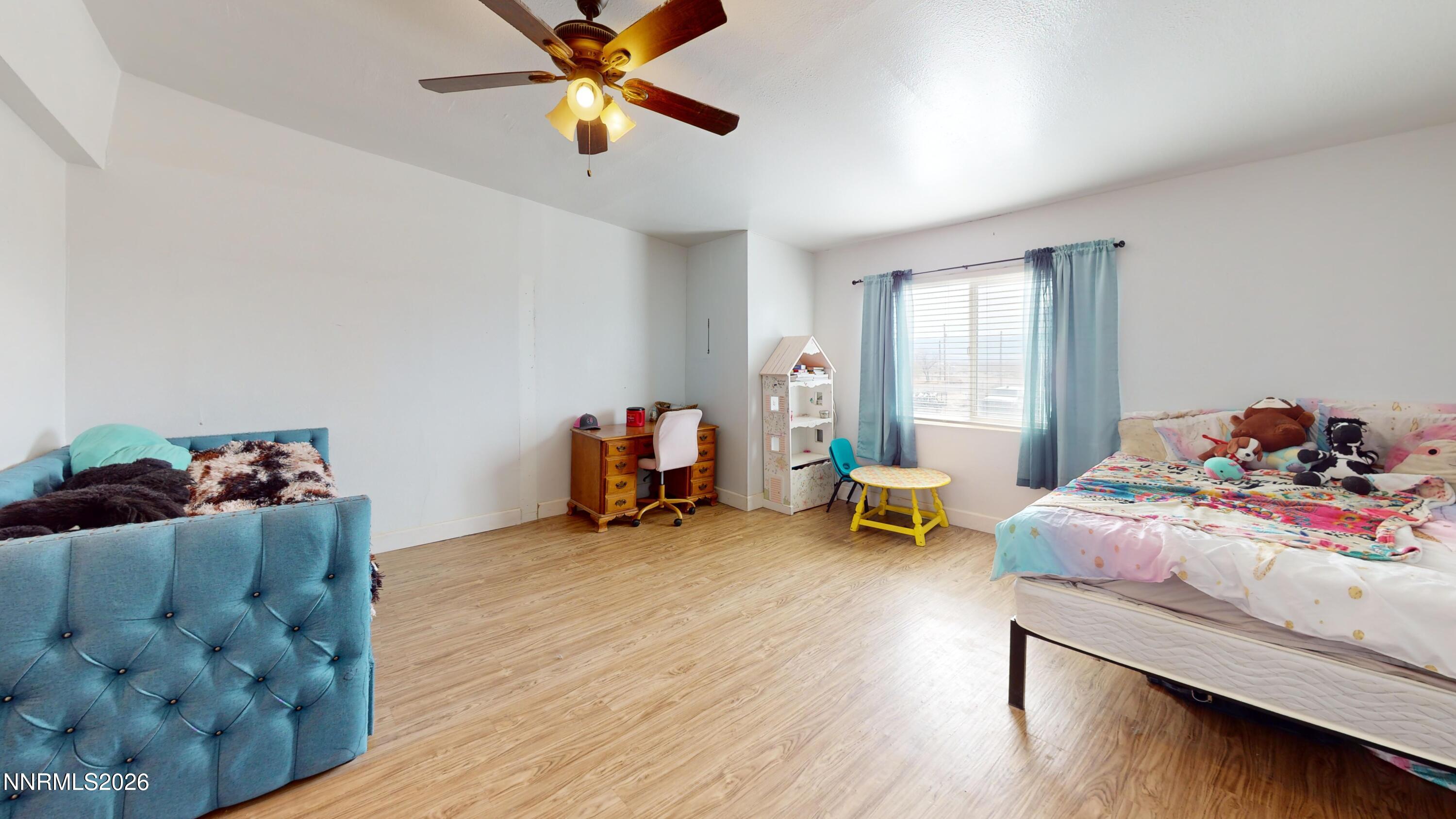 5355 Godchaux Road Winnemucca, NV 89445 - Photo 23 of 37 a bedroom with furniture and a wooden floor