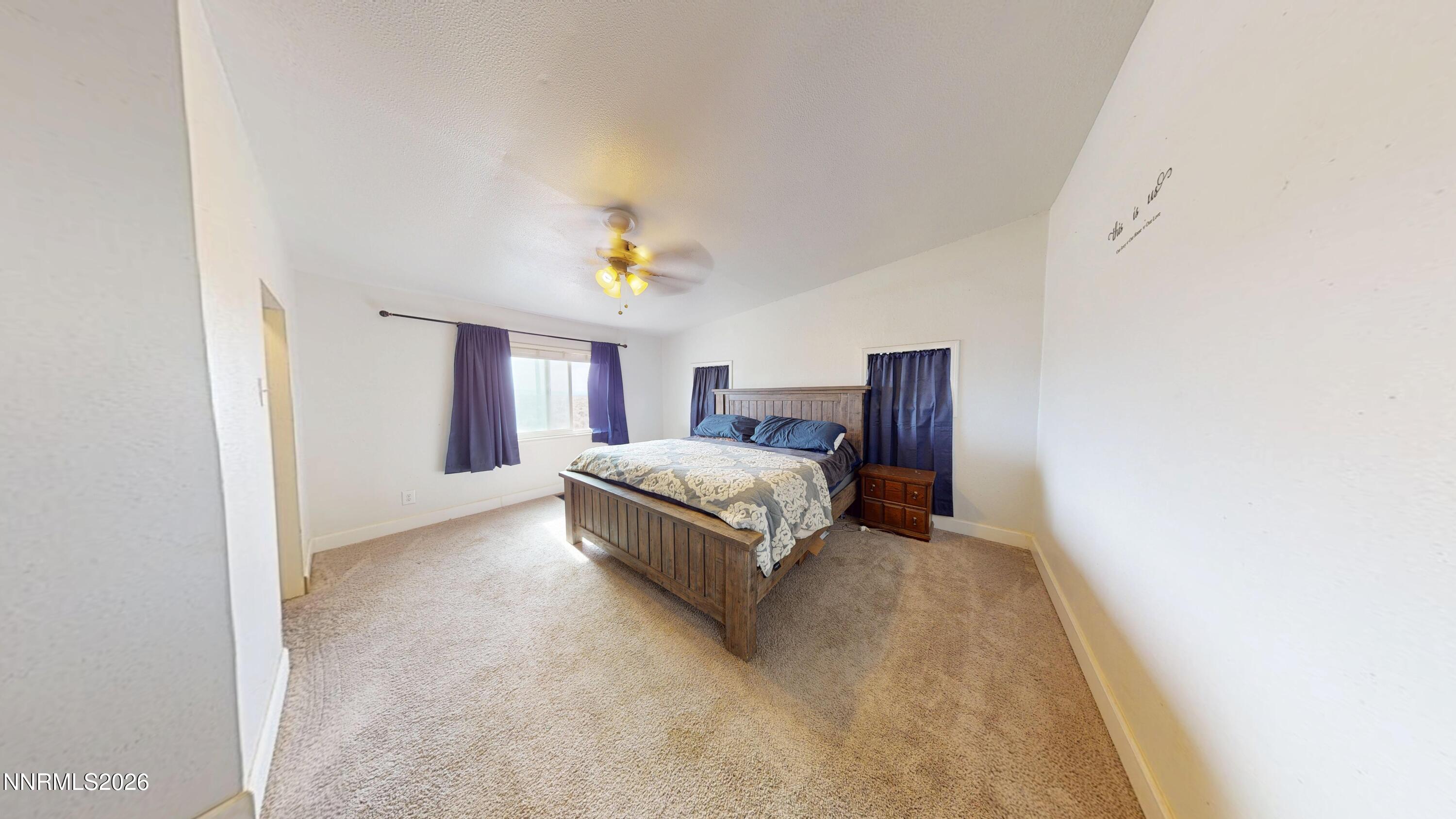 5355 Godchaux Road Winnemucca, NV 89445 - Photo 26 of 37 a spacious bedroom with a bed and a window