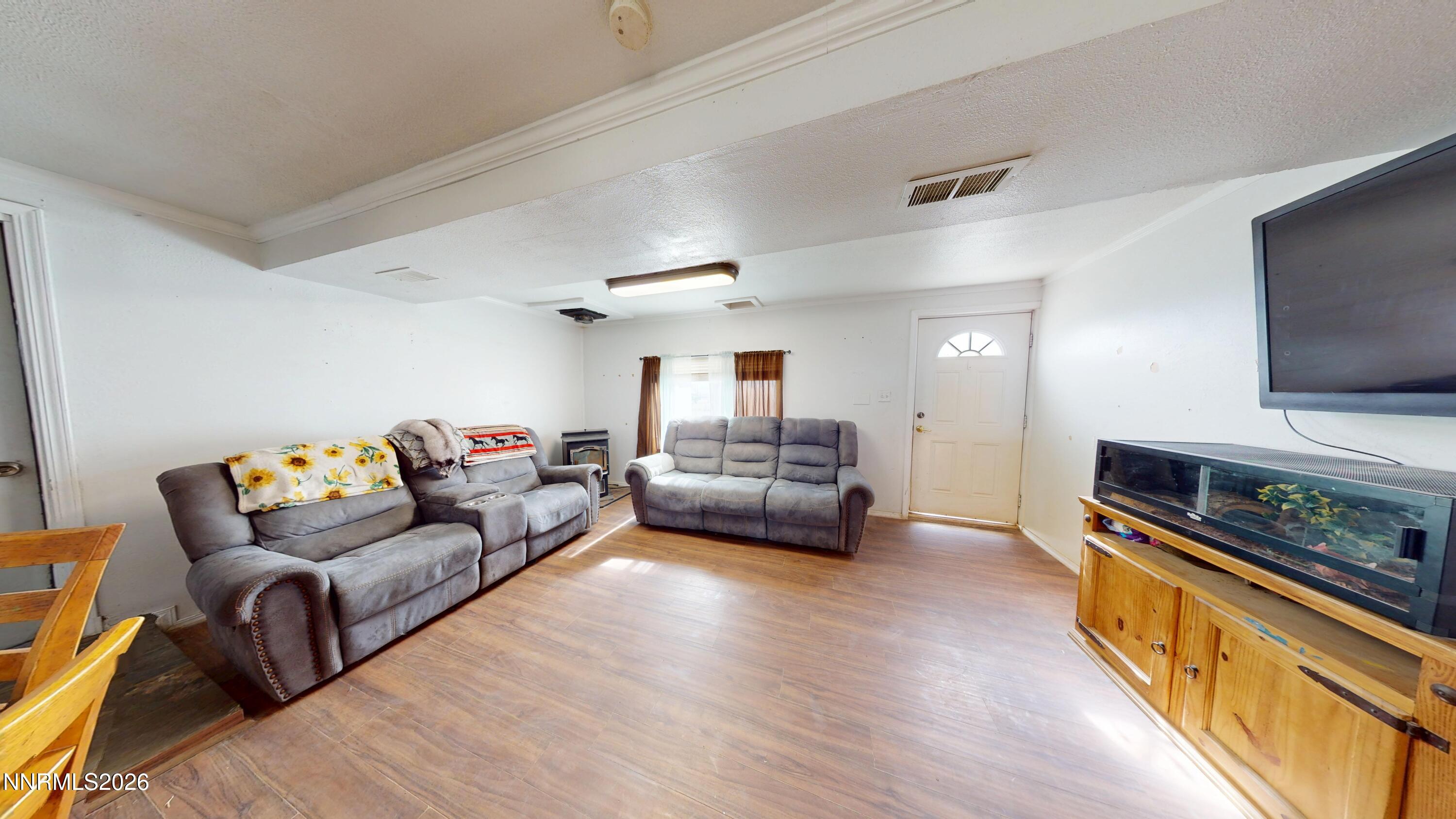 5355 Godchaux Road Winnemucca, NV 89445 - Photo 9 of 37 a living room with furniture and a flat screen tv