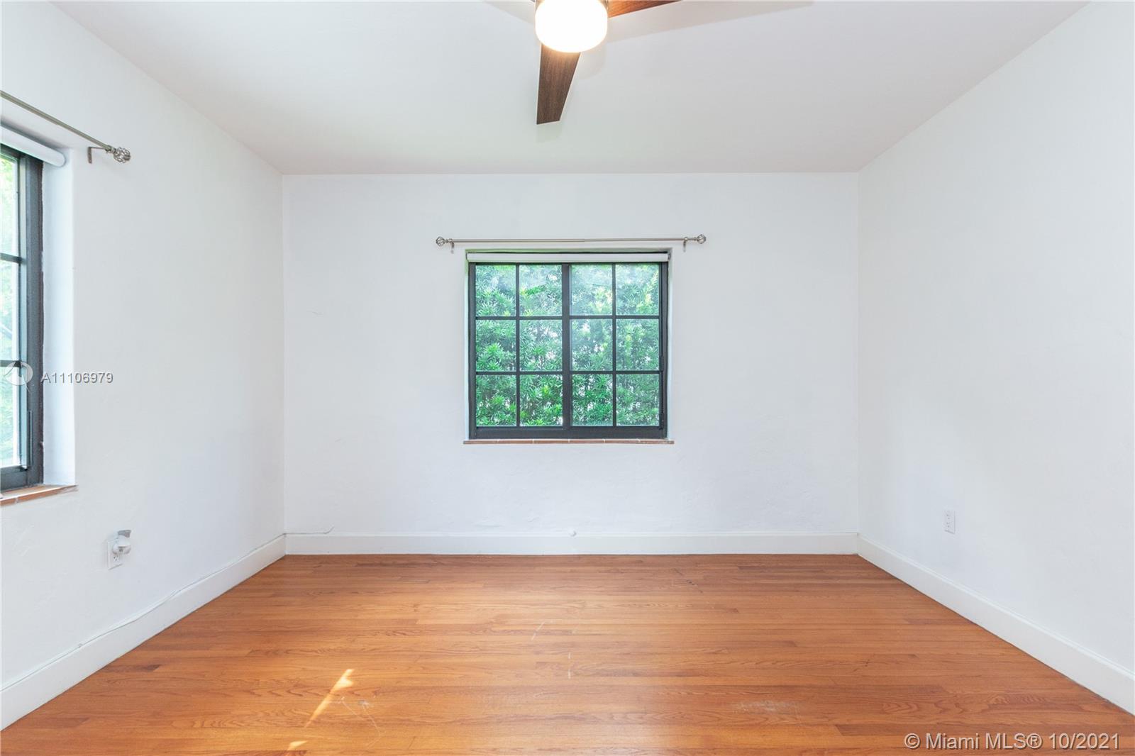 5173 Alton Road Miami Beach, FL 33140 - Photo 12 of 31 an empty room with wooden floor and windows