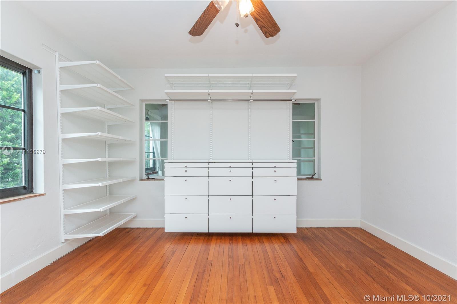 5173 Alton Road Miami Beach, FL 33140 - Photo 21 of 31 wooden floor in an empty room with a window
