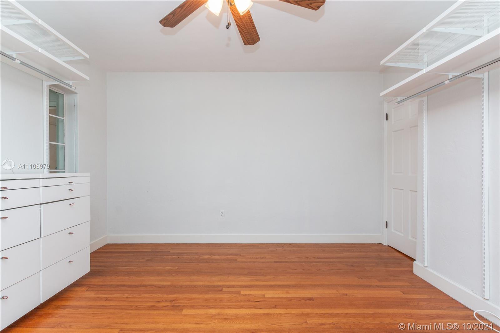 5173 Alton Road Miami Beach, FL 33140 - Photo 22 of 31 a view of an empty room with wooden floor and a window