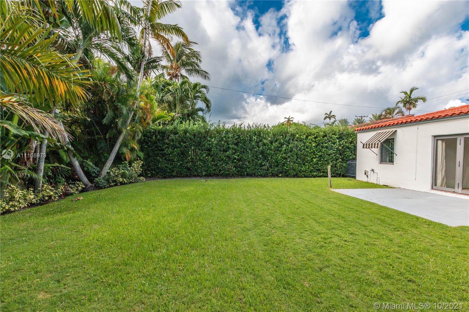 5173 Alton Road Miami Beach, FL 33140 - Photo 26 of 31 a view of a big yard with plants and a large tree