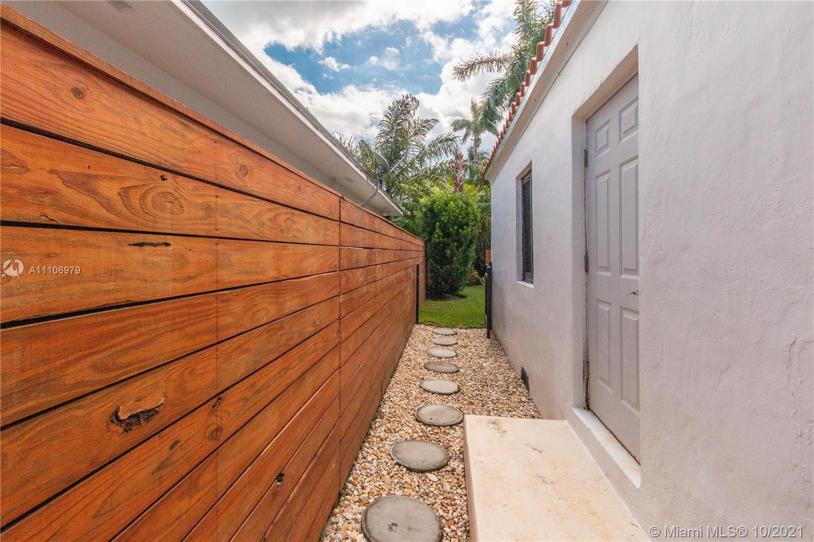 5173 Alton Road Miami Beach, FL 33140 - Photo 30 of 31 a view of a pathway with a house in the background