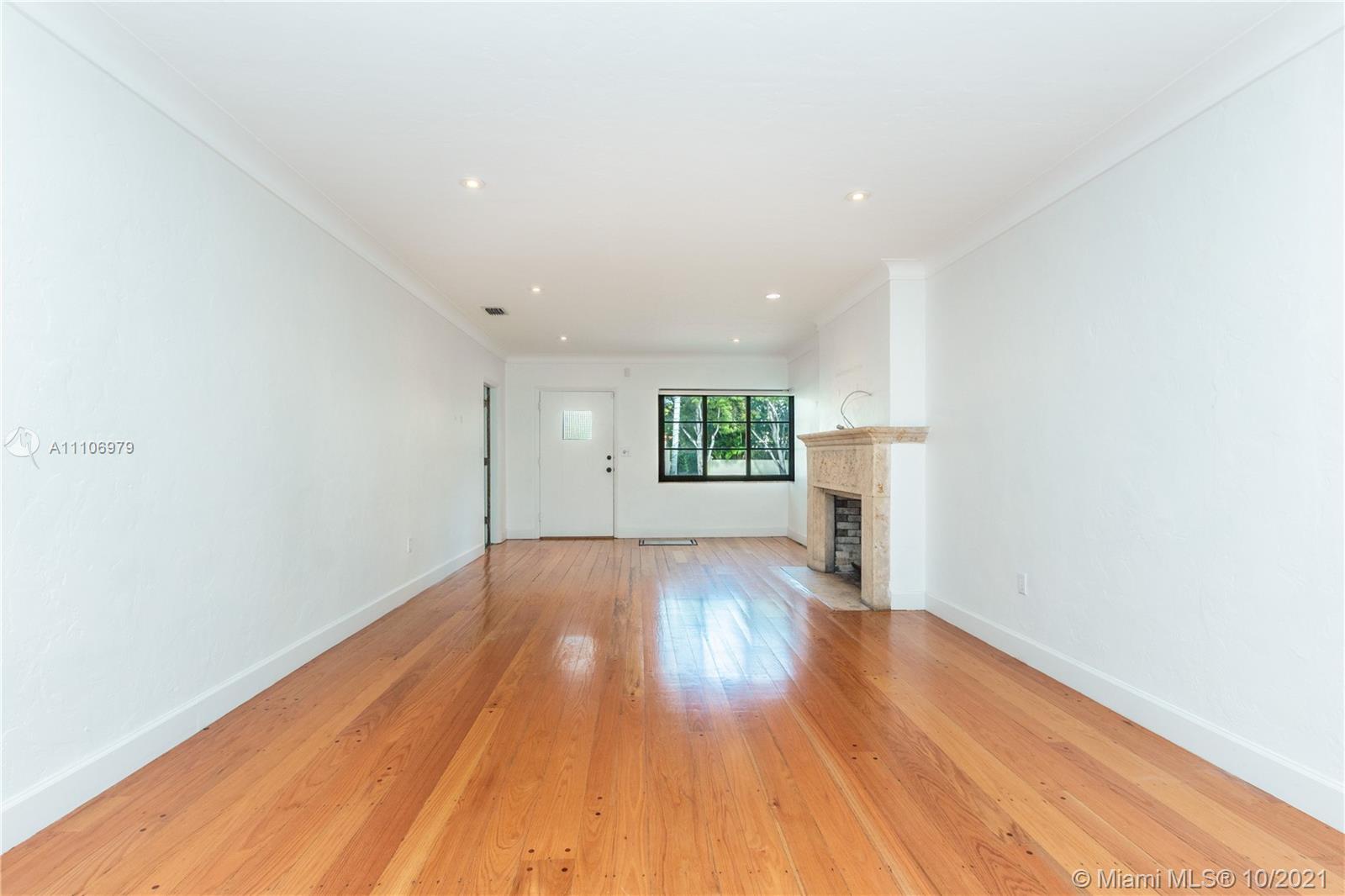 5173 Alton Road Miami Beach, FL 33140 - Photo 4 of 31 an empty room with wooden floor and windows