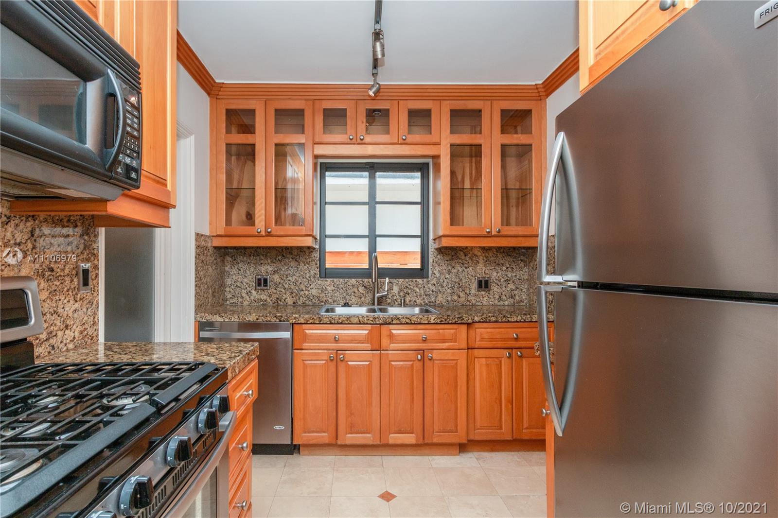 5173 Alton Road Miami Beach, FL 33140 - Photo 6 of 31 a kitchen with granite countertop a refrigerator stove top oven and sink