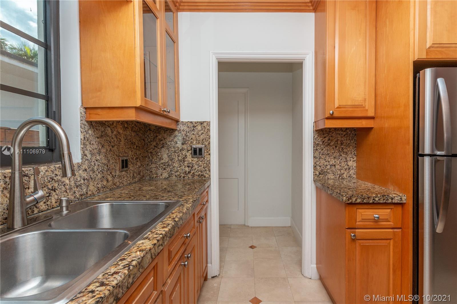 5173 Alton Road Miami Beach, FL 33140 - Photo 8 of 31 a kitchen with a refrigerator and a sink