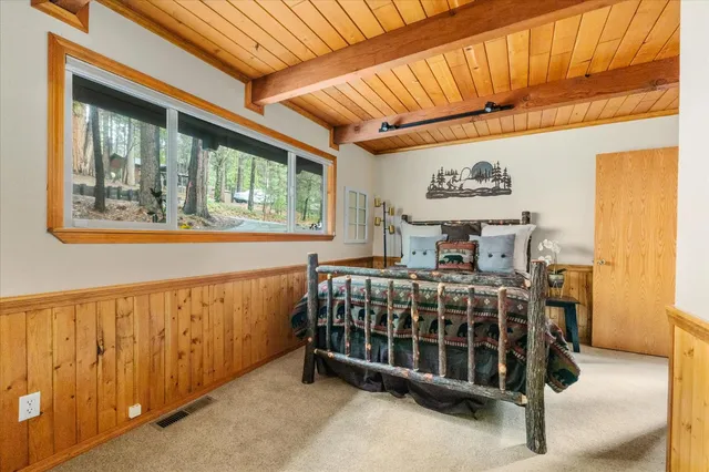 a bed sitting in a room next to a window