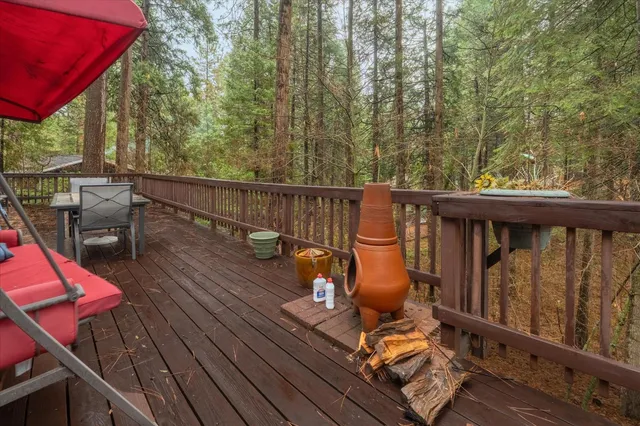 a balcony with wooden floor and outdoor seating