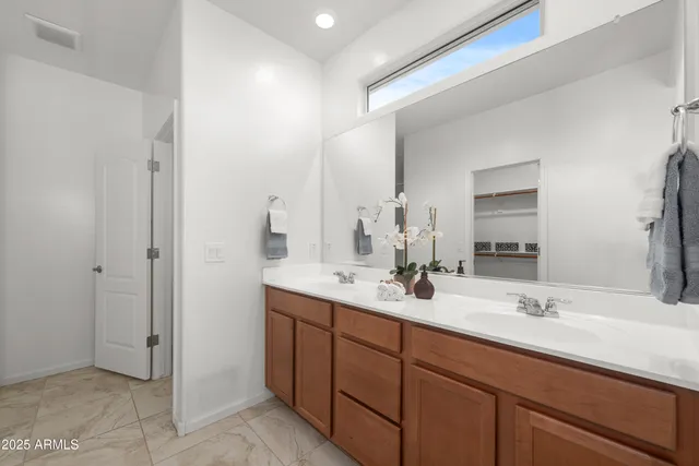 a bathroom with double sink and a mirror